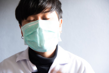 Doctor in white coat on grey background.