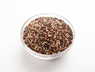 Mix of red, white and black quinoa seeds in glass bowl