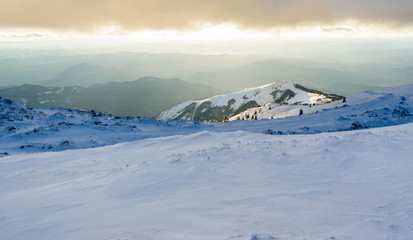 Panorama of winter snowy mountains and sky with sunlit clouds. Kopaonik, Serbia