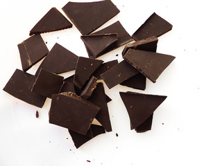 pieces of dark chocolate on white background