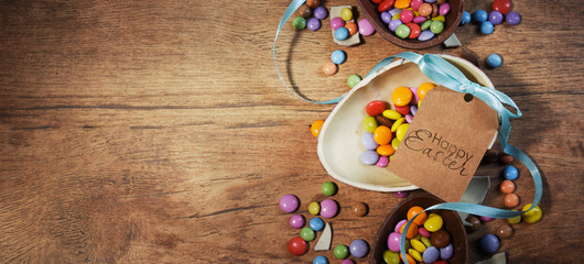 Colorful Easter candies on a rustic wood background