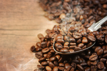 Coffee cup and beans on old kitchen table.