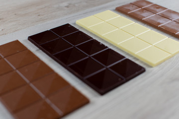 Delicious white, black, hazelnut and milk chocolate flavored chocolate tablets