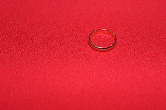 One Engagement Ring On A Red Background. Family Jewels. Wedding Ring