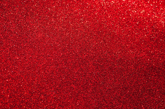 Bright red sparkling glitter full frame textured background