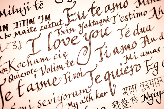 Handmade Valentine's Day message handwritten in calligraphy in many languages. Translation: I love You