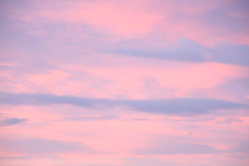 Dreamy evening sky  in pastel tones with fluffy pink clouds at sunset