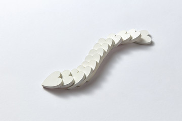 Curve chain from plaster hearts in the shape of snake.