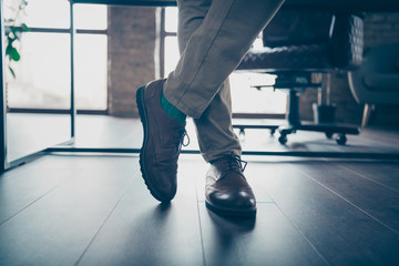 Cropped close-up view of his he nice confident imposing gentleman expert specialist legs crossed standing at industrial loft style work place station