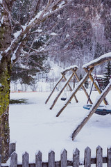 Wooden playground in the snow.