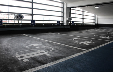 Electric car charging station in indoor parking garage