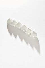 Creative line from plaster inverted hearts with long shadows.