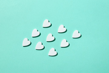 Handmade paper hearts pattern with hard shadows.