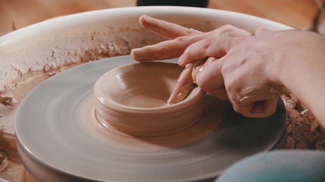 Pottery - the master is unfolding clay with his finger