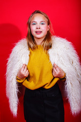 young pretty teenage girl on bright red background, happy smiling lifestyle people concept