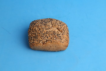 delicious bread rolls on colored background