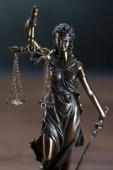 The Statue of Justice or lady justice / Justitia the Roman goddess of Justice in lawyers office
