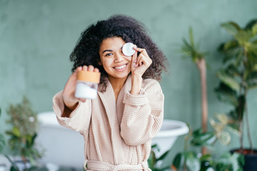 Eco friendly multiethnic female blogger showing her morning routine