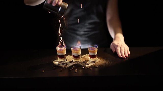 Bartender making B 52 cocktail
