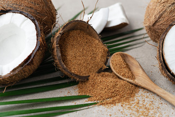fresh coconuts with brown palm sugar on gray stone background