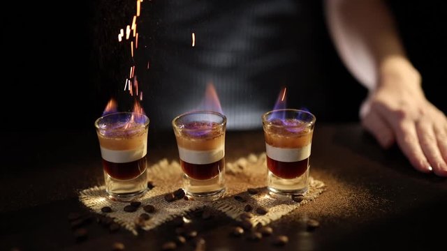 Barmaid preparing B52 cocktail