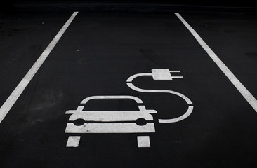 Electric car charging symbol in  parking spot.