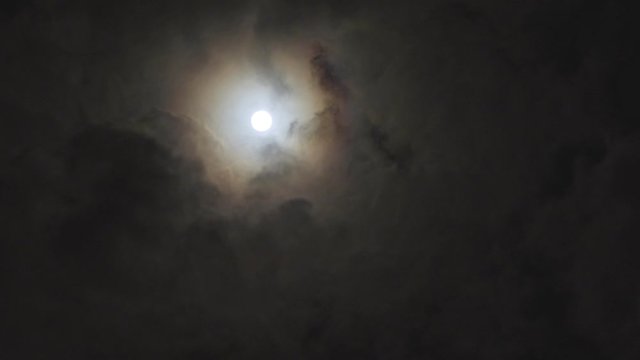 moon with fast moving storm clouds and halo effect