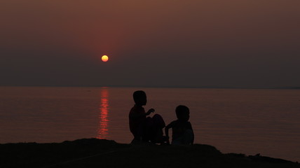 Fototapeta na wymiar Sunset and happy children
