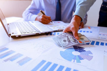 Businessman analyzing investment charts with Accounting.