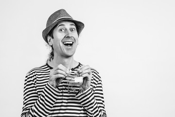 Man holding a supermarket cart isolated on white, copy space. Funny man at supermarket. Man with small shopping cart.
