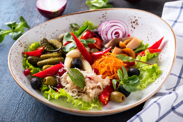 Pickled vegetables on a plate. Different pickled vegetables.
