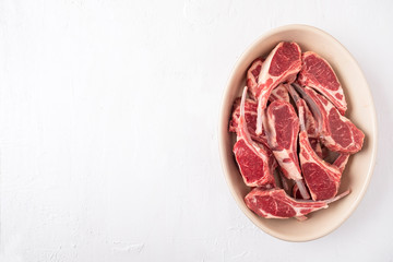 Fresh raw mutton on the bone. Uncooked lamb meat ribs on a white background. Space for text. Copy...