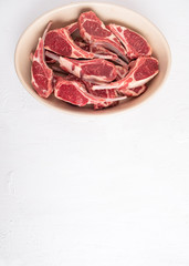  Uncooked lamb meat ribs on a white background. ?opy space