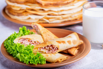 Tasty pancakes with ham and cheese. Breakfast concept.
