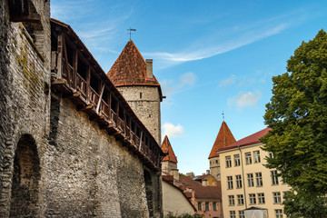 View of limestone walls protecting Tallinn's old town - defence wall with wooden balcony. European and Scandinavian Tallinn city Old Town view. Unesco heritage.