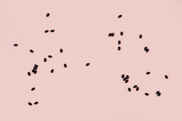 Scattered medical capsules on a pink background. Flat lay, top view, copy space.