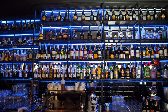 Chernivtsi, Ukraine. December 30, 2019. Bar: Goira. Heroiv Maidanu str. 2V. Alcohol bottles are illuminated with blue neon light.