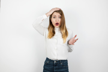 young beautiful blond woman looking lost standing on isolated white background touching her head ,...