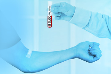 male hand with blood in a test tube and a hand sealed on the ins