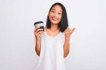 Fototapeta premium Young chinese woman drinking take away glass of coffee over isolated white background screaming proud and celebrating victory and success very excited, cheering emotion