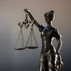 The Statue of Justice or lady justice / Justitia the Roman goddess of Justice in lawyers office