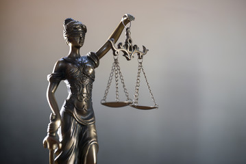The Statue of Justice or lady justice / Justitia the Roman goddess of Justice in lawyers office