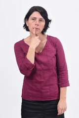 thoughtful woman with a finger in her mouth on white background