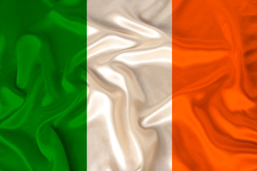 photo of the national flag of Ireland on a luxurious texture of satin, silk with waves, folds and...