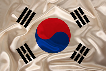 photo of the national flag of South Korea on a luxurious texture of satin, silk with waves, folds and highlights, close-up, copy space, travel concept, economy and state policy, illustration
