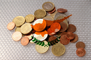 metal currency coins on the background of the national flag of the country of Cyprus, the concept of financial development, devaluation, inflation, taxes