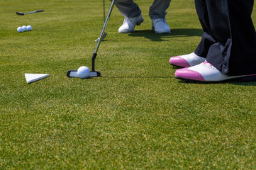 Coach teaching woman golf playing