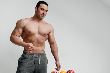 Sexy athlete posing on a white background Topless. Fitness