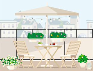 White garden furniture surrounded by plants on the balcony under an umbrella overlooking the city.