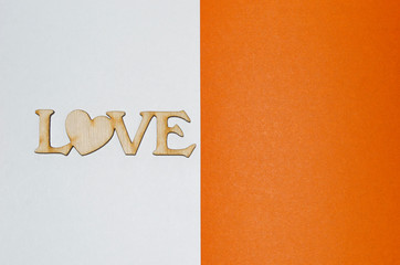 the word love half the page in wooden letters, a place for an inscription, white orange, postcard